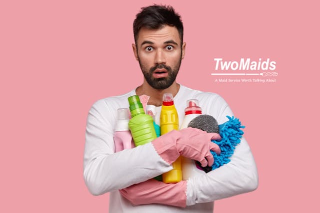 Man holding home cleaning agents