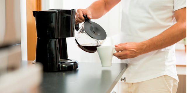 A man pouring a cup of coffee